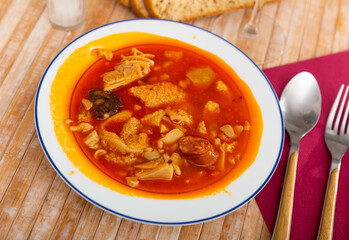 Callos Madrilenos served on table with bread and serving pieces