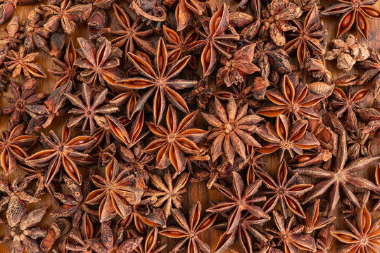 Anise stars on wooden for background, top view.