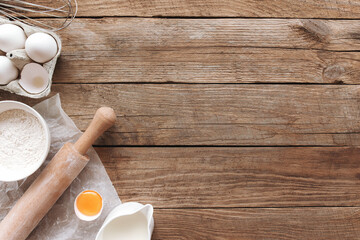 Baking concept flat lay. Ingredients, kitchen utensils, wooden background