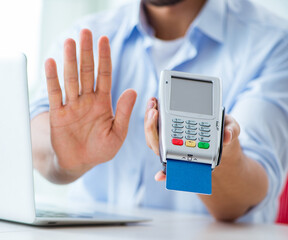 Man processing credit card transaction with POS terminal