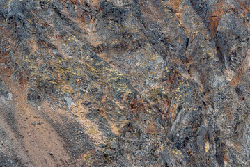 Side of natural mountain rock, slate in Canadas sub arctic region during summer time. Great for background, design use. 