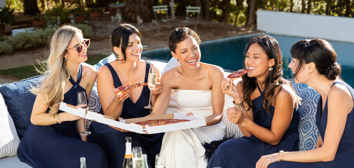 Bride and bridal party enjoy pizza before the wedding. 