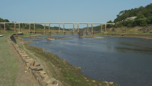 River with little water near a bridge.