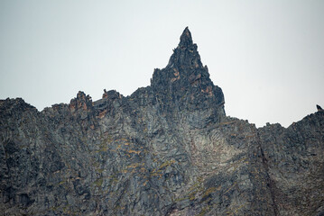 Jagged mountain peaks in northern Canada on a cloudy day with stunning landscape background. 