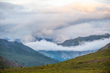 Cloudy, misty, foggy landscape of Tombstone Territorial Park in northern Canada with fog laying low in the valleys. 