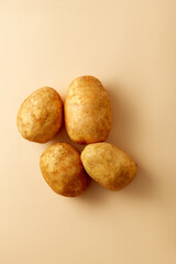 Potato on beige pastel background. Topview, flatlay. Vegetable 