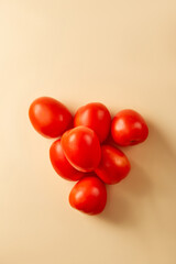 Tomato on beige pastel background. Topview, flatlay. Vegetable 
