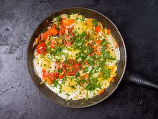 Fried eggs in a frying pan on a black background. Studio photography
