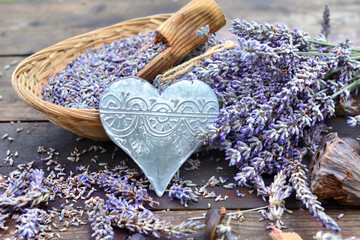 decorative metal heart and little basket full  of lavender on wooden table
