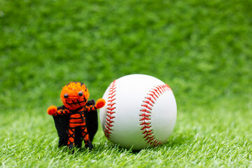 Baseball for Halloween Day on green grass with ghost