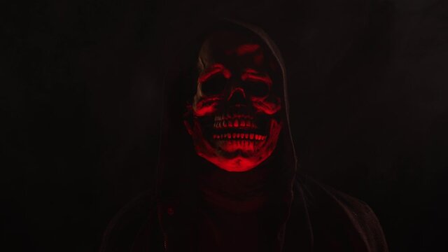 Scary Skeleton skull head figure in a hood for Halloween or horror videos