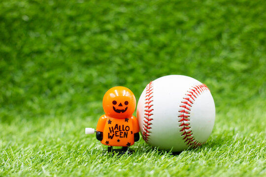 Baseball for Halloween Day on green grass with ghost