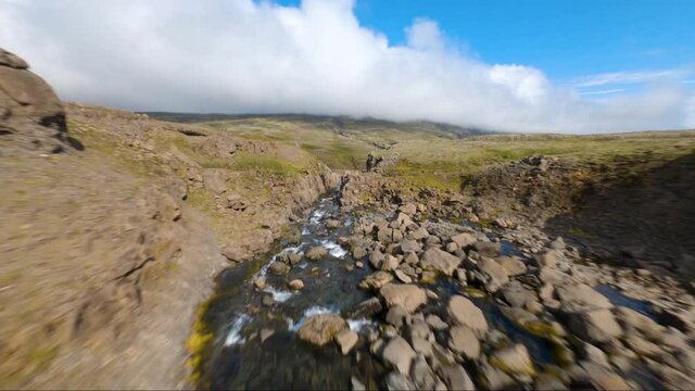 Low altitude proximity flight over a mountain river with an FPV drone in Iceland