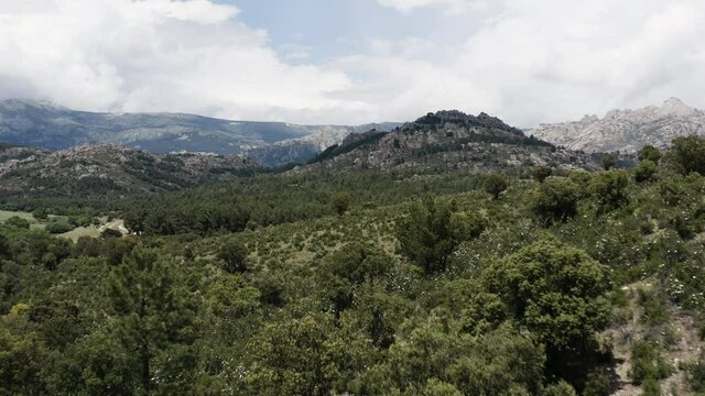 Low level drone aerial over the epic and cinematic mountain ranges of Sierra De Guadarrama in the Parque Nacional del La Pedriza Spain