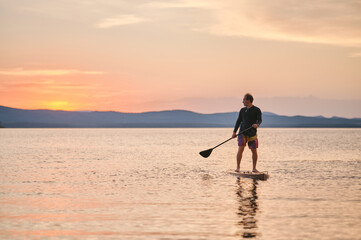 Sportsman paddling the standing board