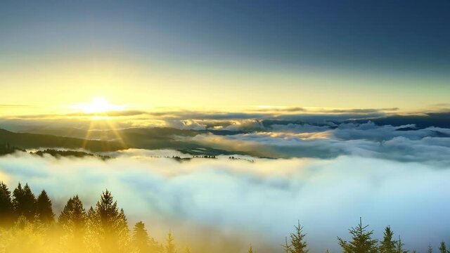 Early in the morning, time lapse of misty clouds over green mountains at sunrise