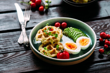 Belgian waffles with avocado, egg and tomato. Healthy breakfast
