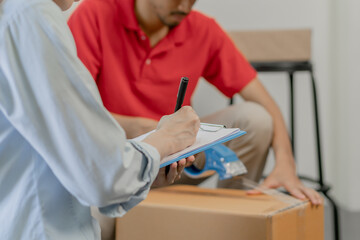 Cargo company delivery man, male packing by tape machine, sealing cardboard box. Owner business...