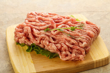 Raw minced pork meat over board