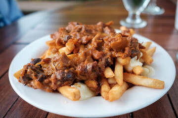 A bowl of french fries Poutine style