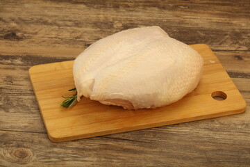 Raw whole chicken breast with skin