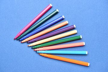 Colorful markers on color background