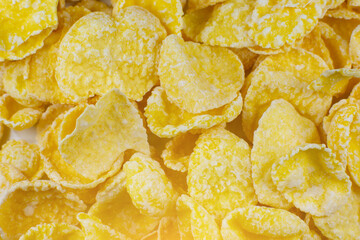 Yellow Cornflakes close up photo, Food texture background, top view. Macro shot. Perfect breakfast.