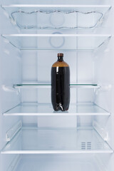 a bottle of kvass, in the refrigerator on a glass shelf, on a white background
