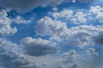Fototapeta na wymiar Group of dark white clouds on fresh blue sky before hard rain. Cumulonimbus cloudy and raining season background. Image for natural phenomenon or meteorology concept.