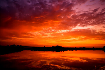 Fototapeta na wymiar Sunrise on the lake, beautiful picture for the oboe with sunrise on the lake
