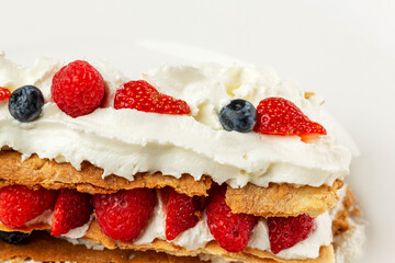 Appetizing dessert with berries. Cookies with strawberries and raspberries. Close-up.