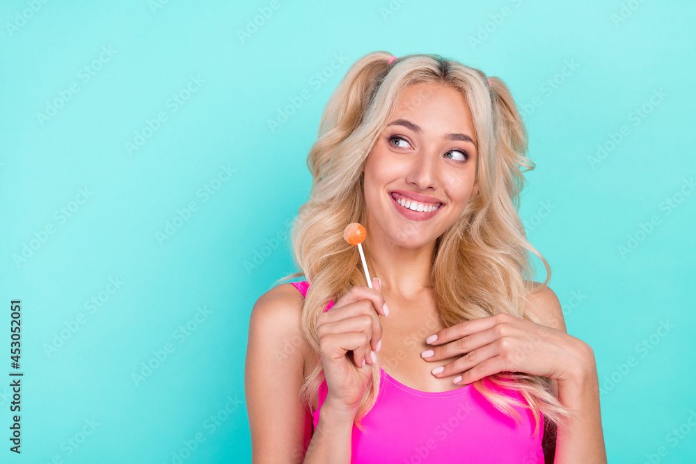 Sticker Photo of young girl happy positive smile dream eat lollypop candy sweet dessert isolated over teal color background