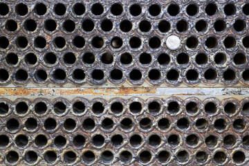 Tube sheet plate of heat exchanger or boiler closeup texture macro background with disconnected...