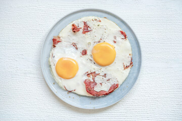 fried eggs with bacon on the table for breakfast