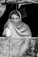 Portrait of a young European girl pretending to be trapped in Kabul. Black and white photography