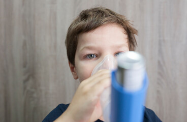 Child boy using medical spray for breath