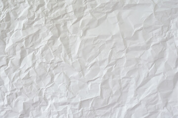 Crumpled white paper as background.