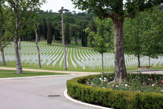 shot of the american military cemetery of the second world war with the crosses of the dead soldiers resting under a beautiful green lawn