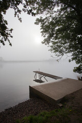 Jetty in the misty river Meuse in Geijsteren in the North of Limburg