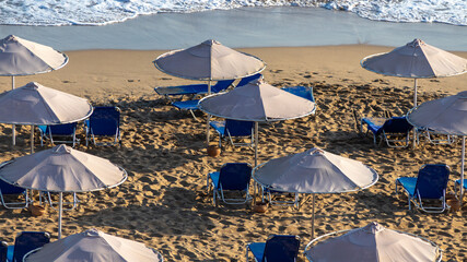 An empty beach with sun beds and umbrellas