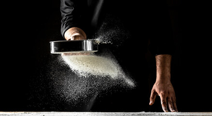 Clap hands of baker with flour. Beautiful and strong men's hands knead the dough make bread, pasta...