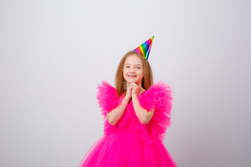 a little girl celebrates her birthday on a white background