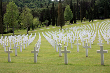 Fototapeta na wymiar shot of the american military cemetery of the second world war with the crosses of the dead soldiers resting under a beautiful green lawn