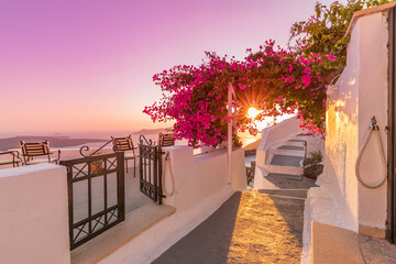 Santorini island sunset. Caldera view with street and flowers, romantic mood, couple travel...