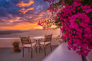 Santorini island sunset. Caldera view with chairs and flowers, romantic mood, couple travel vacation landscape destination scenic. Tourism view, amazing sky sea Greece mood. Summer romance holiday