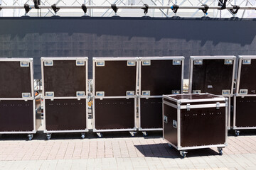 Row big metal boxes with professional sound equipment. Preparing for mass event on city street....