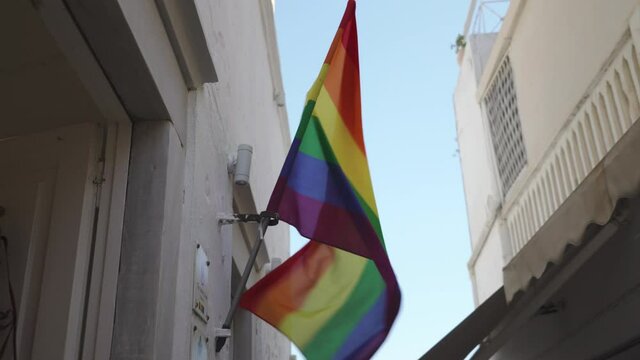 LGBT flag flies in a narrow street in Fira, Santorini