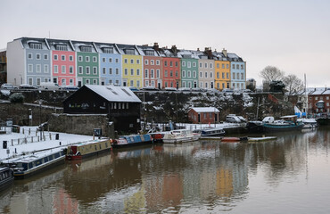 Snow covered colorful houses on the historic floating Harbourside in Bristol, England