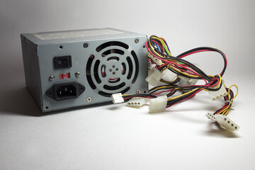 computer ATX power supply unit rear side with fan and line power socket. colorful power cords for...