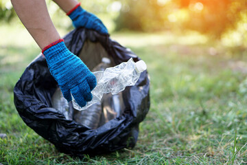 Concept : Environment conservation. Volunteer pick up  bottle garbage that other people threw away and left in the park.  Cleaning public place activity. Recycle waste. 